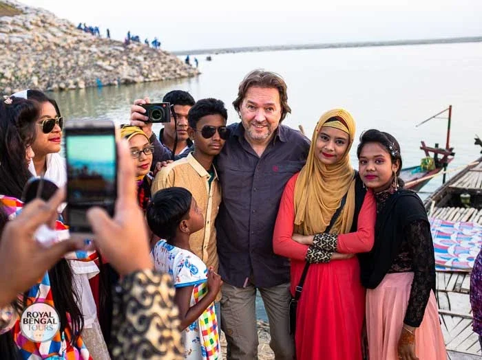 a group of local folks are taking memorable picture with tourist
