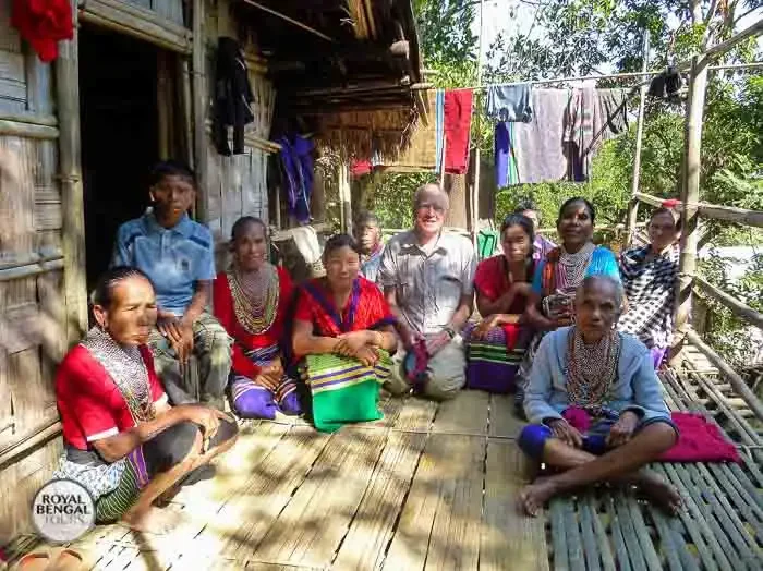 tribal family welcoming a foreign tourst at their home