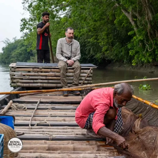 Fishermen setting up nets for otter assisted fishing on the river